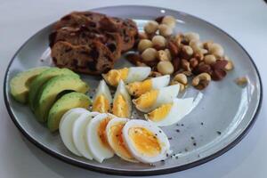 walnut cranberry sourdough bread or cranberry sourdough with boiled egg , avocado and nuts photo