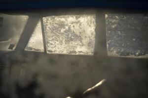 Frozen glass. Ice on the window. Snowflakes on the surface. photo