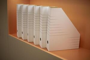 Empty folders stand in a row. A place to store documents. Folders on the shelf. photo