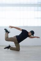 cool looking dancer makes a difficult trick photo