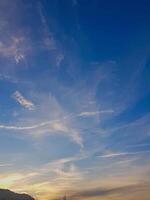 Vibrant cloudscape, where fluffy formations dance across the sky. The sunlight reflects off the soft, billowy clouds, creating a stunning interplay of light and shadow that enhances the vivid colors. photo