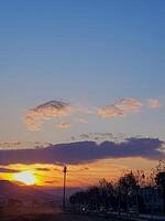 Sunset that creates a picturesque scene, where the warm hues of the setting sun cast a golden glow photo