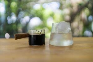 Making of ice coffee, shot of espresso and cool water ready to making black coffee photo