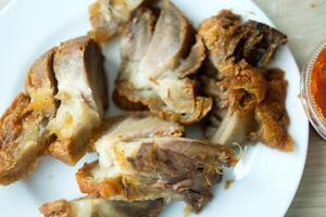 Crispy fried pork legs. Crispy pork cut into bite-sized pieces. photo