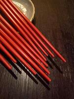 Many of red chopsticks on plate photo