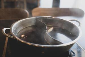 Combo pot for two flavors of hot pot soup base photo