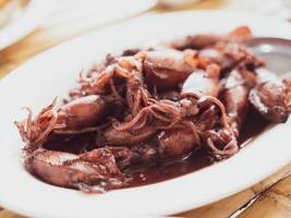 Sauteed black squid is processed squid that is cooked until the squid ink is released. The resulting taste is very distinctive. photo