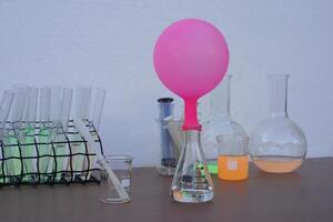 Science experiment , pink inflated balloon on top of transparent test bottle. The experiment about air or gas reaction by using baking soda and vinegar. Concept, Science Education photo