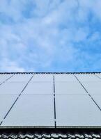 Snow covered solar panels do not produce clean energy on a roof photo