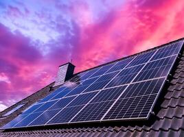 Solar panels producing clean energy on the roof of a house with a spectacular sky photo