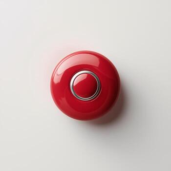 A bright red button on a smooth surface, adding a pop of color to a minimalistic setting. photo