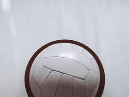 Close-up of a white volleyball against a neutral backdrop, highlighting its detailed stitching. photo