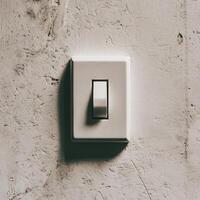 Minimalistic light switch on a textured wall, creating a serene atmosphere. photo