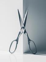 Shiny silver scissors positioned at a sharp corner, creating a dynamic visual effect. photo