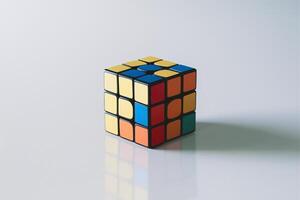 A classic Rubik's Cube with vibrant colors set against a minimalist background. photo