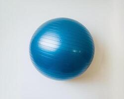 A blue exercise ball on a clean, white background. photo
