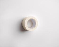 A roll of clear adhesive tape on a minimalist white background. photo
