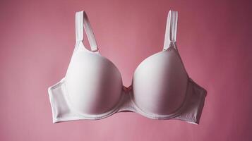 Elegant white bra against a soft pink background, emphasizing comfort and style. photo