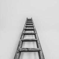 A wooden ladder stretching upward against a minimalistic white background, creating a sense of ascent. photo