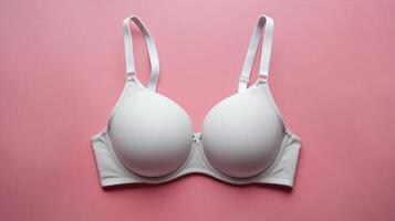 Elegant white bra on a pink background, showcasing a minimalist design for modern lingerie aesthetics. photo