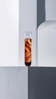 Artistic still life of a test tube with swirling brown liquid against minimalistic backdrop. photo