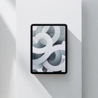 A sleek tablet displaying abstract white curves on a gray background, emphasizing modern design. photo