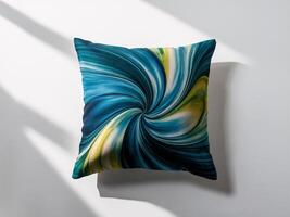 Bright patterned pillow with swirling blue and green design on a light background. photo