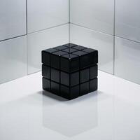 A sleek black Rubik's cube stands out in a minimalist environment with reflective surfaces. photo