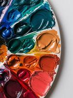 A vibrant palette displaying a spectrum of paint colors in various shades and textures. photo