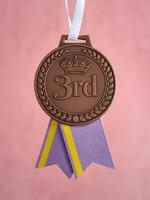 Bronze medal for third place with a decorative ribbon, symbolizing achievement and success. photo