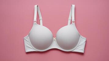 Elegant white bra displayed on a soft pink background, emphasizing comfort and style. photo