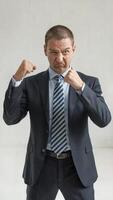 Stressed Businessman Clenching Fists. Depiction of Corporate Pressure, Frustration, and Workplace Challenges. Business and Stress Management Concept. photo