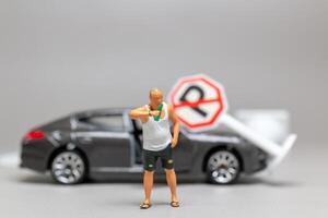 A Drunk driver holding a liquor bottle as he steps out of a car. concepts of reckless behavior, urban life photo