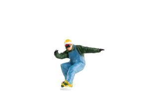 Miniature figurine depicting a snowboarder in mid-motion isolate on white background with clipping path photo