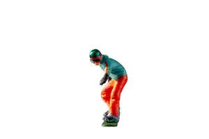 Miniature figurine depicting a snowboarder in mid-motion isolate on white background with clipping path photo