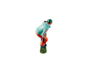 Miniature figurine depicting a snowboarder in mid-motion isolate on white background with clipping path photo