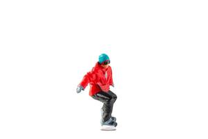Miniature figurine depicting a snowboarder in mid-motion isolate on white background with clipping path photo