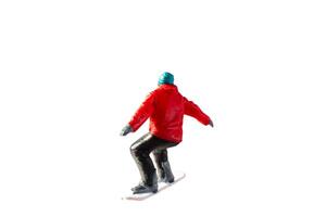 Miniature figurine depicting a snowboarder in mid-motion isolate on white background with clipping path photo