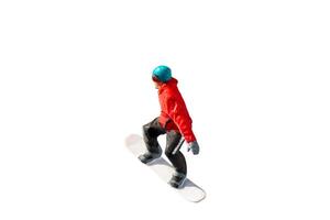 Miniature figurine depicting a snowboarder in mid-motion isolate on white background with clipping path photo