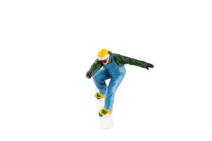 Miniature figurine depicting a snowboarder in mid-motion isolate on white background with clipping path photo
