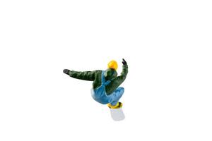 Miniature figurine depicting a snowboarder in mid-motion isolate on white background with clipping path photo