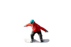 Miniature figurine depicting a snowboarder in mid-motion isolate on white background with clipping path photo