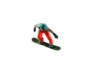 Miniature figurine depicting a snowboarder in mid-motion isolate on white background with clipping path photo
