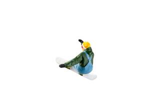 Miniature figurine depicting a snowboarder in mid-motion isolate on white background with clipping path photo
