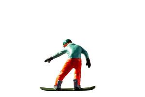 Miniature figurine depicting a snowboarder in mid-motion isolate on white background with clipping path photo
