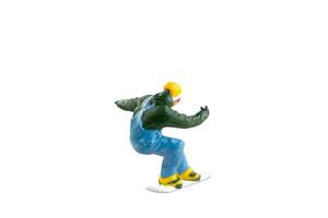 Miniature figurine depicting a snowboarder in mid-motion isolate on white background with clipping path photo