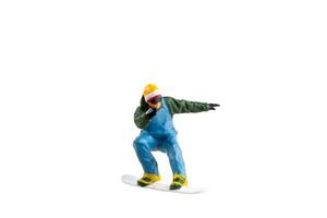 Miniature figurine depicting a snowboarder in mid-motion isolate on white background with clipping path photo