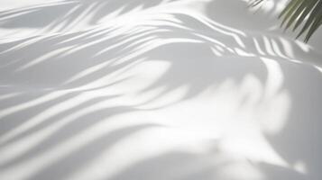 Natural palm leaf shadows on white sand surface, tropical minimal background with sunlight, ideal for summer, travel, beauty, wellness, and branding designs photo