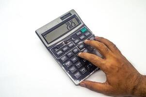 A hand using a calculator displaying the year 2025, symbolizing future financial planning or budgeting. The image highlights the importance of financial foresight photo