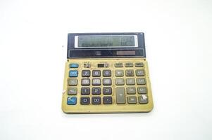 A vintage calculator with a worn out keypad and display showing deal for retro technology or office nostalgia concepts photo